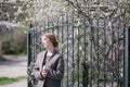 Young beautiful woman near trees in blossom in spring Royalty Free Stock Photo