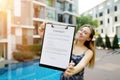 Young beautiful woman offers to sign contract. Focus on document. Front used with Open Font License