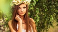 Young beautiful woman outdoor in a birchwood wearing wreth of daisy Royalty Free Stock Photo