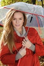 Young beautiful woman in the park in a fashion shot, looking away and smiling - caucasian woman, autumn, fall, park, umbrella