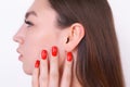 Young beautiful woman with perfect skin touching her ear. Cosmet