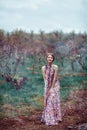 Young beautiful woman in a pink dress in the misty forest. Fairy tale, fantasy, legend Royalty Free Stock Photo