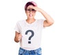 Young beautiful woman with pink hair holding question mark stressed and frustrated with hand on head, surprised and angry face Royalty Free Stock Photo