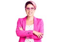 Young beautiful woman with pink hair wearing business jacket and glasses happy face smiling with crossed arms looking at the Royalty Free Stock Photo
