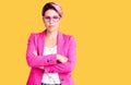 Young beautiful woman with pink hair wearing business jacket and glasses skeptic and nervous, disapproving expression on face with Royalty Free Stock Photo