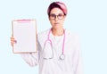 Young beautiful woman with pink hair wearing doctor stethoscope holding clipboard with medical report thinking attitude and sober Royalty Free Stock Photo