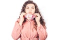 Young beautiful woman in pink suit on white background. She wears protective mask of blooming flowers on her face. Breathe fresh Royalty Free Stock Photo