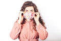 Young beautiful woman in pink suit on white background. She wears protective mask of blooming flowers on her face. Breathe fresh Royalty Free Stock Photo