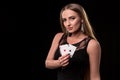 Young beautiful woman playing in casino. Girl holding the winning combination of poker cards. Two aces Royalty Free Stock Photo