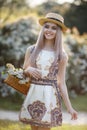 Young beautiful woman with a pleasant smile in alone in a wreath of fresh flowers walks in a spring flowering park Royalty Free Stock Photo