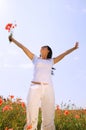 Young beautiful woman in poppy field