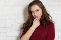 Young beautiful woman portrait on white brick wall background. Royalty Free Stock Photo