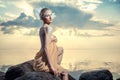 Young beautiful woman posing on the beach at sunset Royalty Free Stock Photo