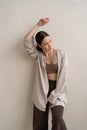 young beautiful woman posing in beige lingerie in the studio, standing near the window Royalty Free Stock Photo