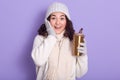 Young beautiful woman posing with smile and surprised facial expression, drinking tea from thermo mug, moving towards zero waste, Royalty Free Stock Photo