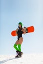 Young beautiful woman posing with a snowboard on a ski slope Royalty Free Stock Photo