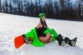 Young beautiful woman posing with a snowboard on a ski slope Royalty Free Stock Photo