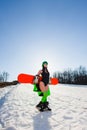 Young beautiful woman posing with a snowboard on a ski slope Royalty Free Stock Photo