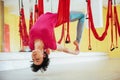 Young beautiful woman practicing yoga Fly with a hammock in the bright studio. The concept of mental and physical health Royalty Free Stock Photo