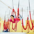 Young beautiful woman practicing yoga Fly with a hammock in the bright studio. The concept of mental and physical health Royalty Free Stock Photo