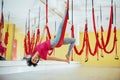 Young beautiful woman practicing yoga Fly with a hammock in the bright studio. The concept of mental and physical health Royalty Free Stock Photo