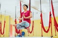 Young beautiful woman practicing yoga Fly with a hammock in the bright studio. The concept of mental and physical health Royalty Free Stock Photo