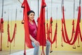 Young beautiful woman practicing yoga Fly with a hammock in the bright studio. The concept of mental and physical health Royalty Free Stock Photo