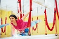 Young beautiful woman practicing yoga Fly with a hammock in the bright studio. The concept of mental and physical health Royalty Free Stock Photo