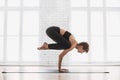 Young beautiful woman practicing yoga near floor window in yoga studio. Girl doing exercises at class. Royalty Free Stock Photo