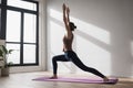 Young beautiful woman practicing yoga near floor window in yoga studio. Young beautiful girl doing exercises at home. Royalty Free Stock Photo