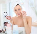 Young beautiful woman putting makeup on Royalty Free Stock Photo