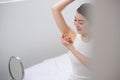 Young beautiful woman raises her hands and shows her perfect clean smooth healthy skin of the armpits Royalty Free Stock Photo