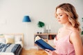 young beautiful woman reading book at home in cozy weekend morning Royalty Free Stock Photo