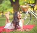Young beautiful woman reading book outdoors in park on a sunny day Royalty Free Stock Photo