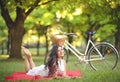 Young beautiful woman reading book outdoors in park on a sunny day Royalty Free Stock Photo