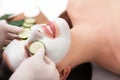 Young beautiful woman receiving clay facial mask in spa beauty salon. Skin care, Beauty treatments. Royalty Free Stock Photo