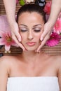 Young beautiful woman receiving facial massage