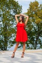 Young beautiful woman in red dress on the summer street Royalty Free Stock Photo