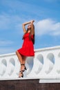 Young beautiful woman in red dress on the summer street Royalty Free Stock Photo