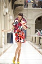 Young beautiful woman in red flowers dress