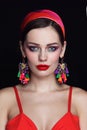 Young beautiful woman with red lips and fancy massive earrings Royalty Free Stock Photo