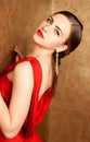 Young beautiful woman with red lips in red dress