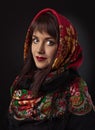 young beautiful woman in a red traditional Russian shawl on black background Royalty Free Stock Photo