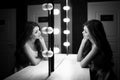 Young beautiful woman and reflection in dressing room Royalty Free Stock Photo