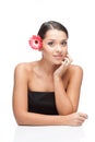 Young beautiful woman relaxing with gerbera flower at spa isolated Royalty Free Stock Photo