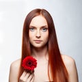 Young beautiful woman relaxing with gerbera flower at spa isolated Royalty Free Stock Photo