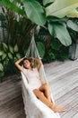 Young beautiful woman relaxing in hammock