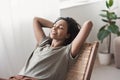 Young beautiful woman relaxing at home. Cute african american girl resting in her room