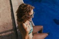 young beautiful woman relaxing at the swimming pool at sunset. Vacation lifestyle outdoors Royalty Free Stock Photo