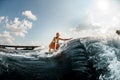 young beautiful woman rides down the wave on a wakeboard Royalty Free Stock Photo